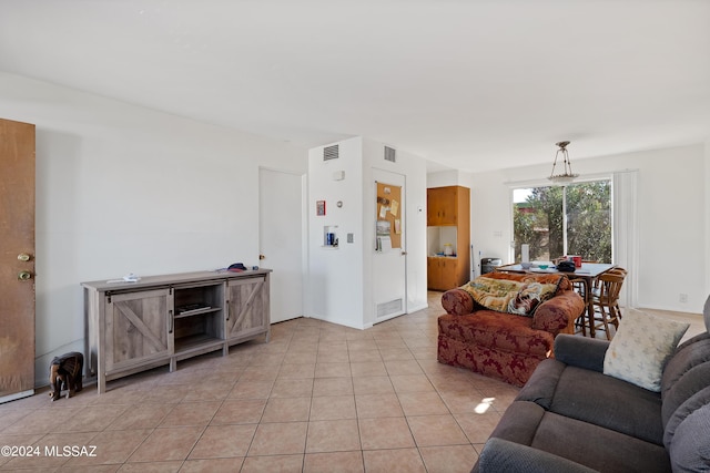 living room featuring light tile patterned flooring and visible vents