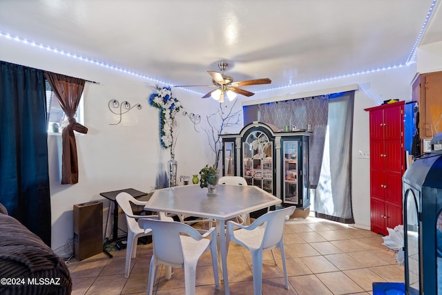 dining area featuring light tile patterned floors and a ceiling fan