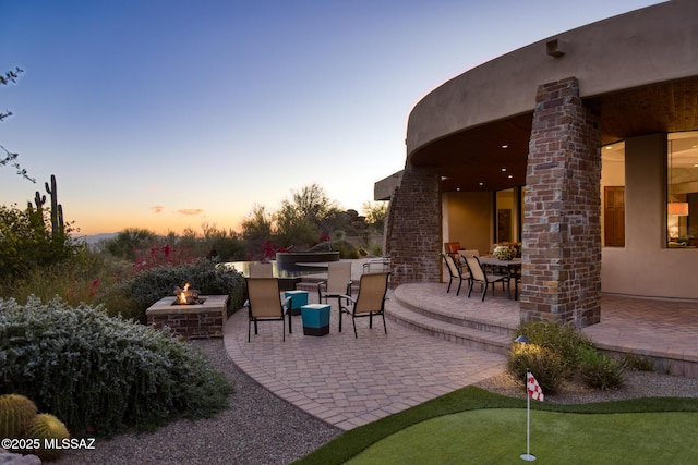 view of patio / terrace featuring outdoor dining space and an outdoor fire pit