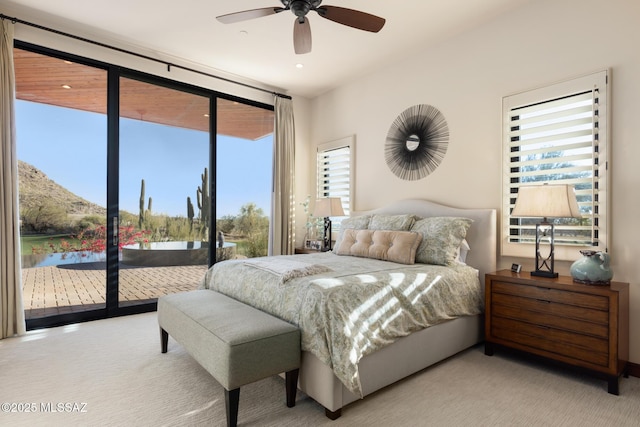 carpeted bedroom with access to exterior and a ceiling fan