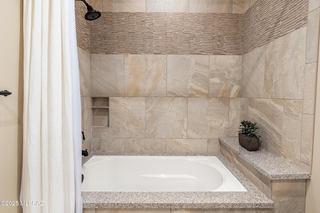 bathroom with a bathtub and a tile shower