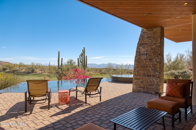 view of patio / terrace featuring a mountain view