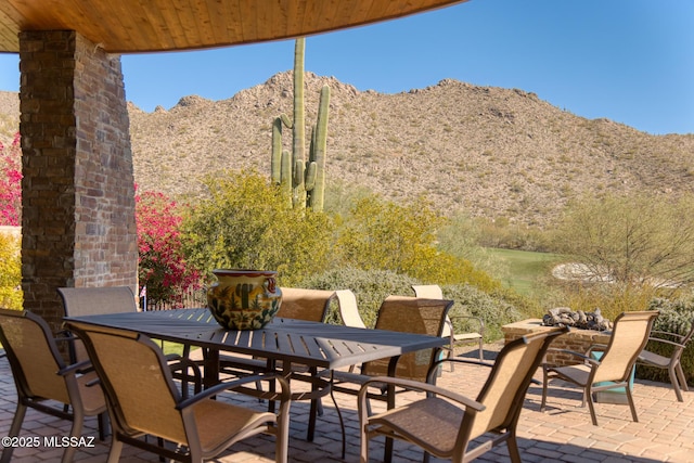 view of patio / terrace with outdoor dining space and a mountain view