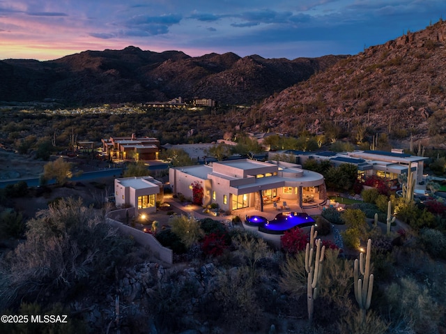 aerial view at dusk featuring a mountain view