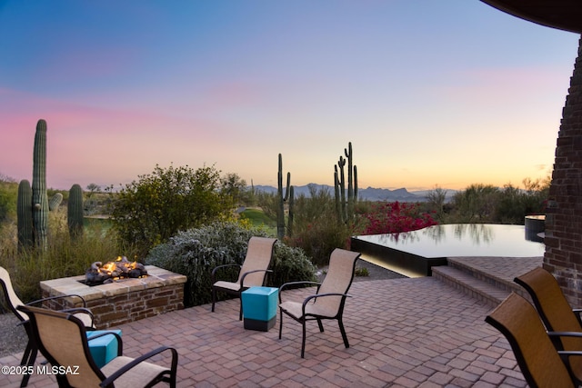 patio terrace at dusk with an outdoor fire pit