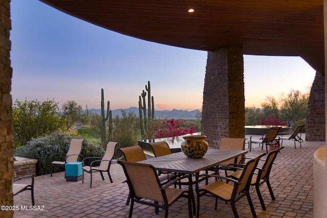 view of patio featuring a mountain view and outdoor dining area