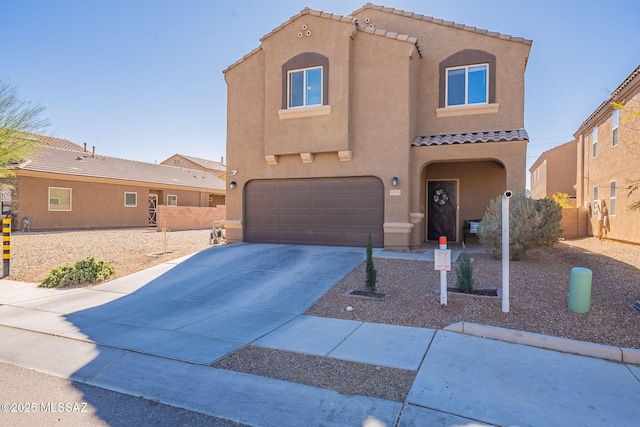 view of front of property featuring driveway, a tile roof, an attached garage, fence, and stucco siding