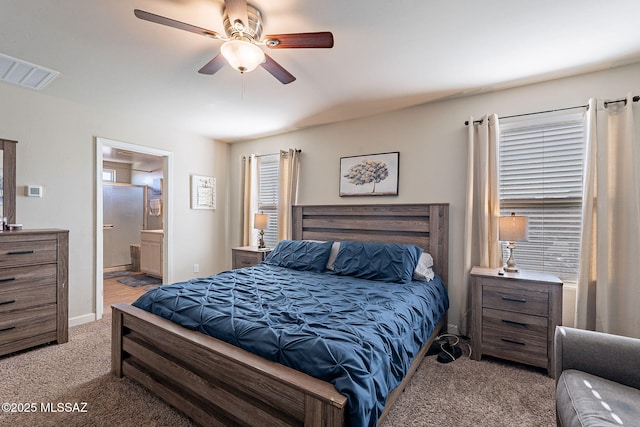 bedroom with ceiling fan, visible vents, connected bathroom, and light colored carpet