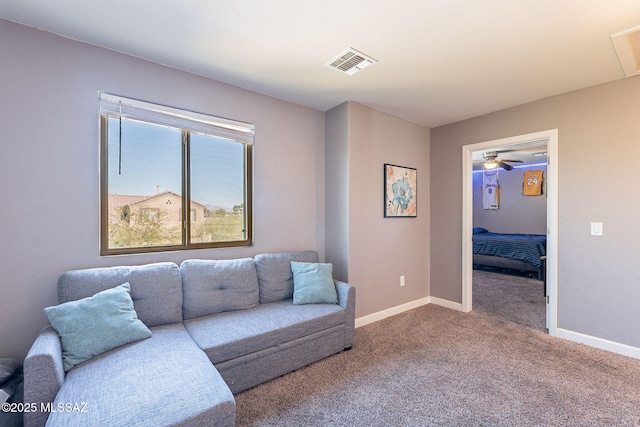 carpeted living room with baseboards and visible vents