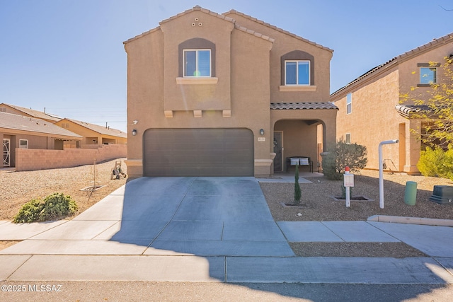 view of front of home with a garage, fence, concrete driveway, a tiled roof, and stucco siding