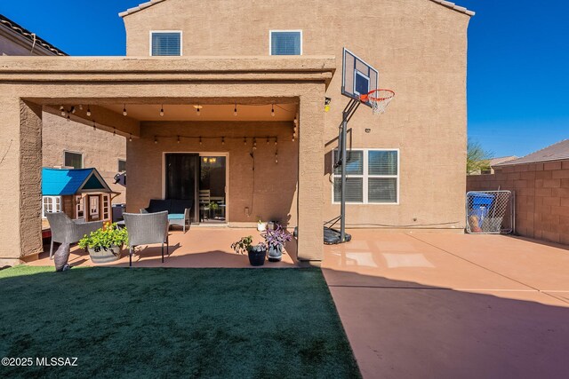 back of house with a lawn, fence, a patio, and stucco siding