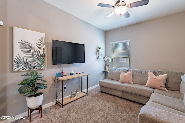 carpeted living room featuring baseboards and a ceiling fan