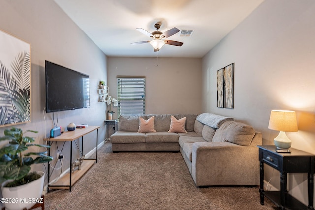 living area with baseboards, ceiling fan, visible vents, and carpet flooring