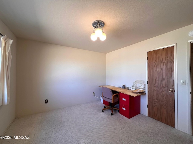 carpeted home office with a textured ceiling