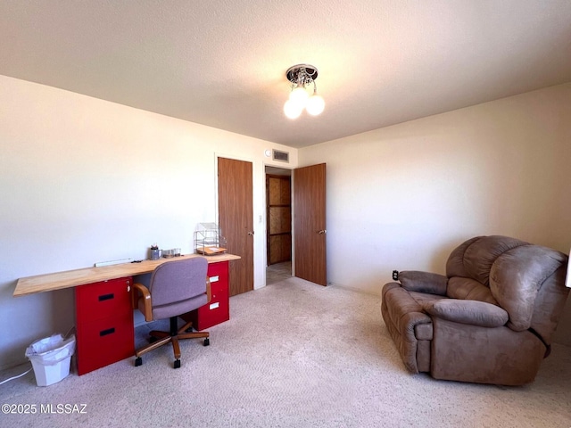 carpeted home office with visible vents and a textured ceiling