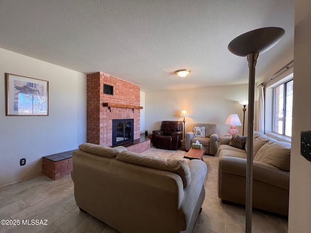 living area with a textured ceiling, a brick fireplace, and visible vents