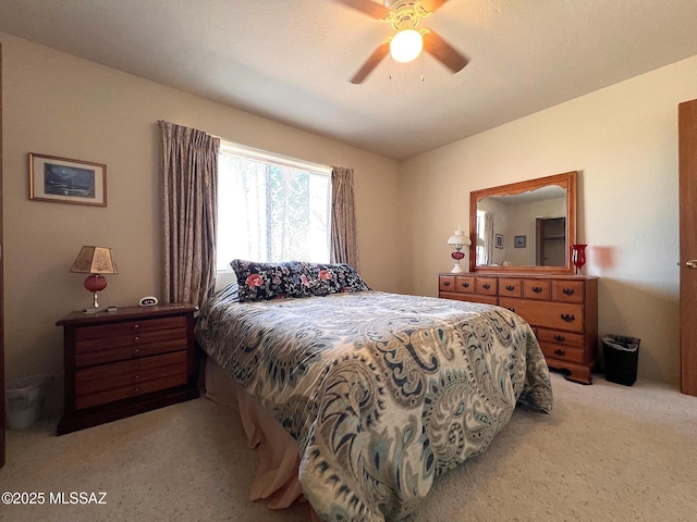 bedroom featuring light carpet and ceiling fan