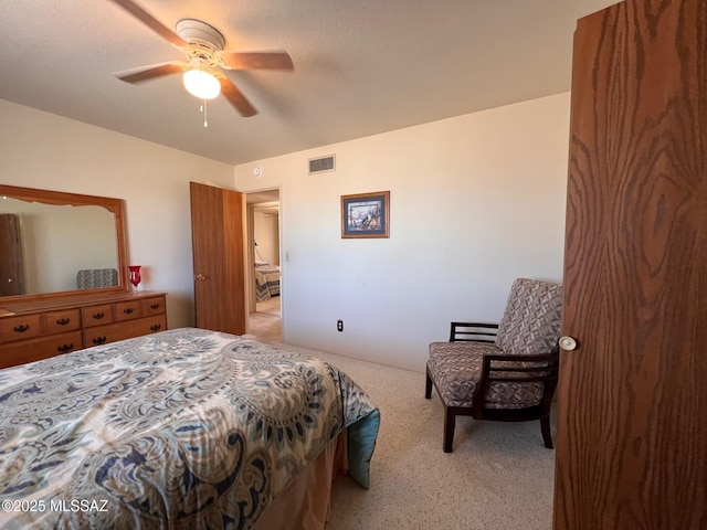 carpeted bedroom featuring ceiling fan and visible vents