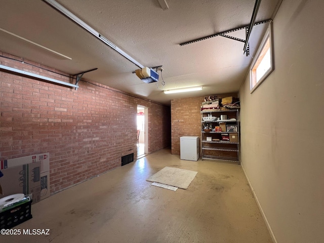 garage featuring a garage door opener and visible vents