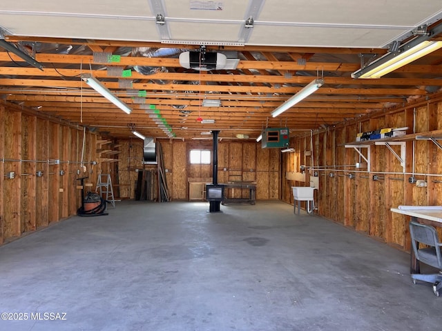 garage with a wood stove and a garage door opener