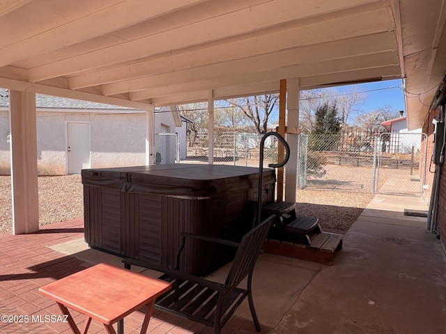 view of patio / terrace with fence and a hot tub