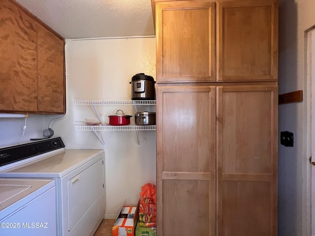 laundry area featuring cabinet space, a textured ceiling, and independent washer and dryer