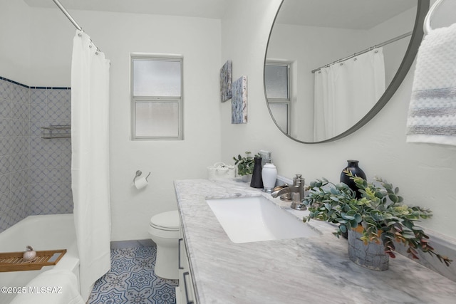 full bath with tile patterned flooring, shower / tub combo with curtain, vanity, and toilet