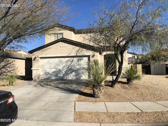 view of front of property with a garage, driveway, fence, and stucco siding