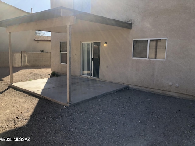 back of property featuring a patio area, fence, and stucco siding