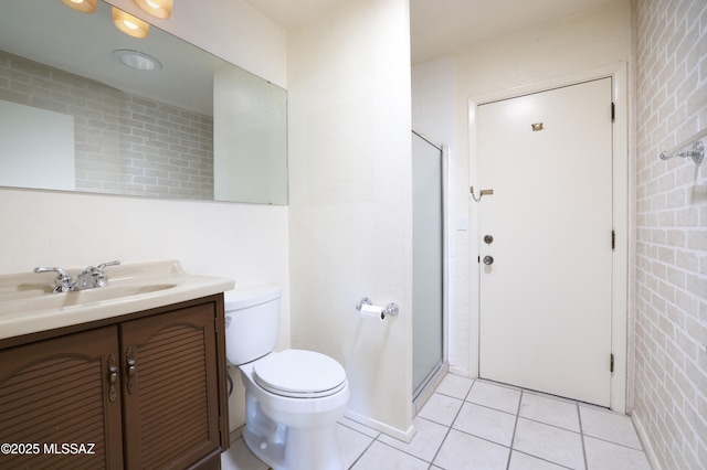 full bath featuring toilet, a stall shower, vanity, and tile patterned floors