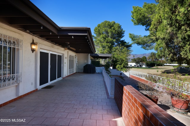 view of patio / terrace with a ceiling fan and area for grilling