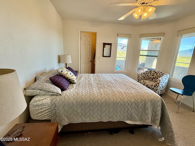 bedroom with ceiling fan, carpet flooring, and baseboards