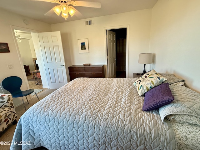 carpeted bedroom featuring visible vents, ceiling fan, and baseboards