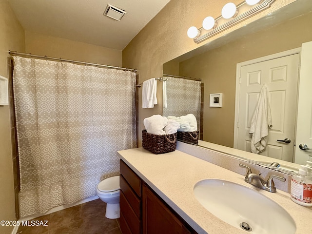 bathroom with curtained shower, visible vents, toilet, vanity, and tile patterned flooring