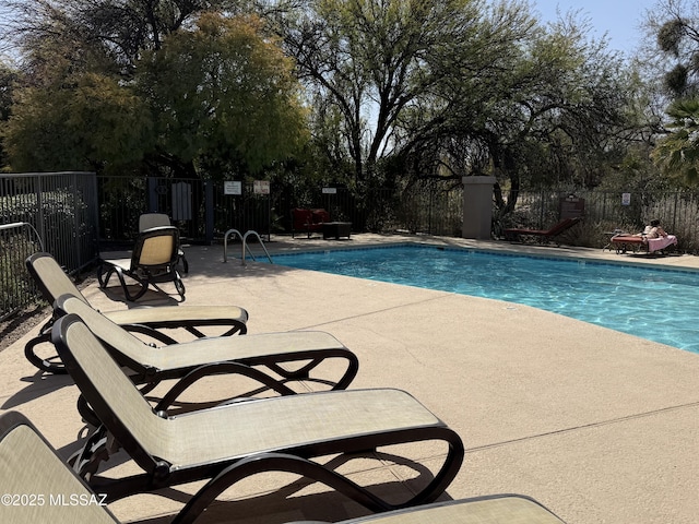 pool featuring a patio area and fence