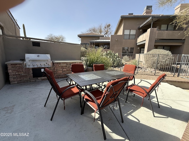 view of patio / terrace with grilling area, fence, outdoor dining area, and area for grilling