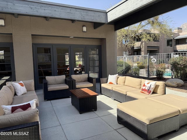 view of patio featuring fence, an outdoor living space, and french doors