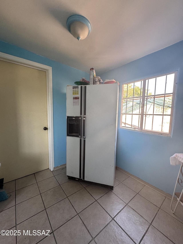 5017 S 11th Ave, Tucson, AZ 85706 - kitchen featuring white fridge with ice dispenser and light tile patterned flooring