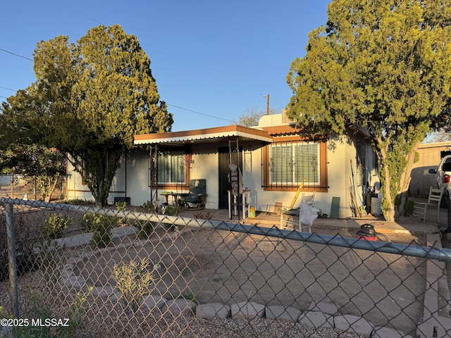 back of property featuring a patio area, fence, and stucco siding