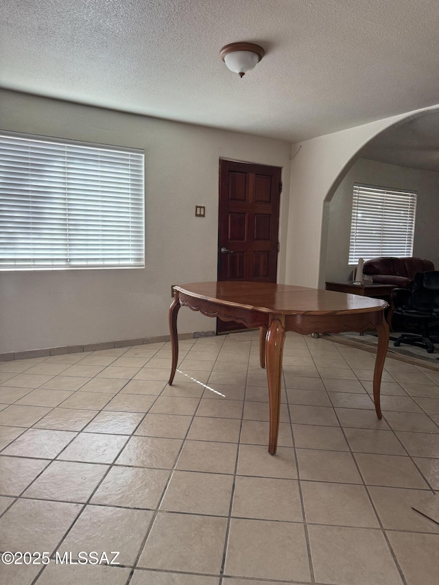 5017 S 11th Ave, Tucson, AZ 85706 - dining area with arched walkways, a textured ceiling, and light tile patterned floors