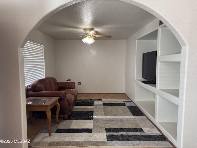 5017 S 11th Ave, Tucson, AZ 85706 - living room with ceiling fan, wood finished floors, arched walkways, and a textured ceiling