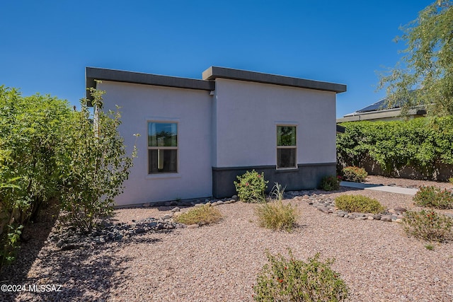 view of side of home featuring stucco siding