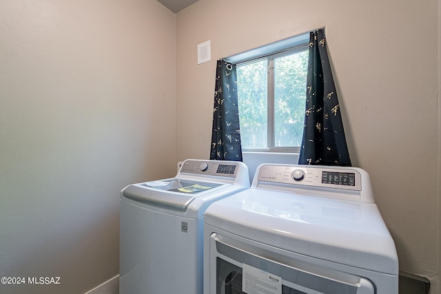 laundry room with visible vents, separate washer and dryer, and laundry area