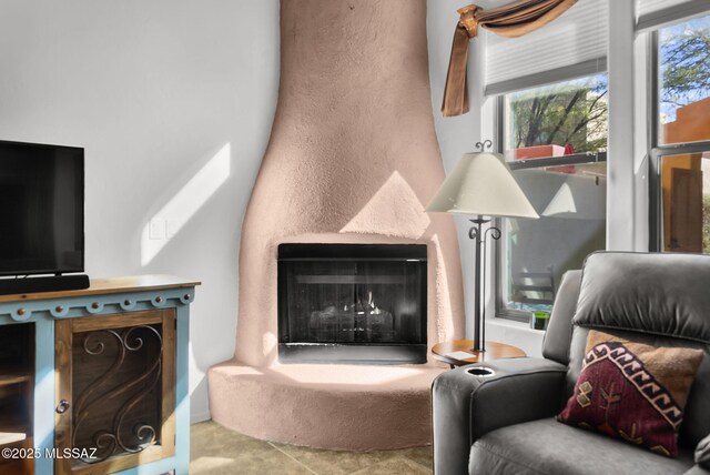 living area with a fireplace with raised hearth