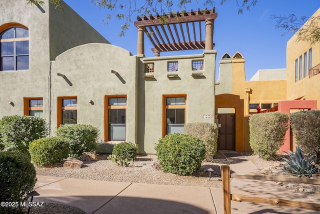 view of front of house featuring a pergola and stucco siding