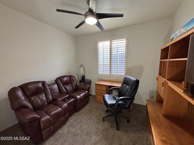 carpeted home office with a ceiling fan