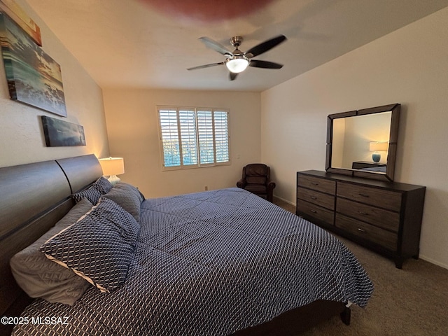 carpeted bedroom featuring baseboards and a ceiling fan
