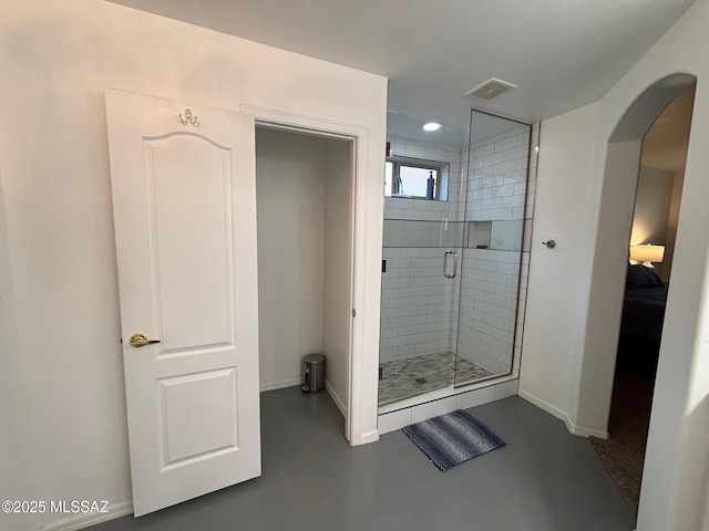ensuite bathroom with visible vents, a shower stall, concrete flooring, baseboards, and recessed lighting