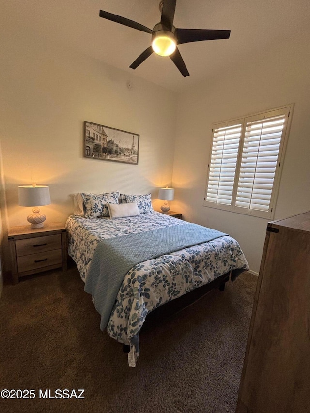 bedroom featuring a ceiling fan and dark carpet