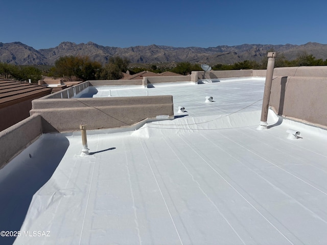 exterior details with a mountain view and a flat roof